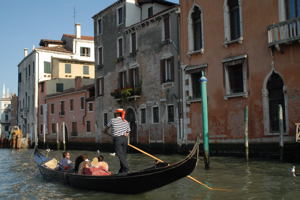 Gondolier with couple in Venice, Italy Gondolier with couple in Venice, Italy